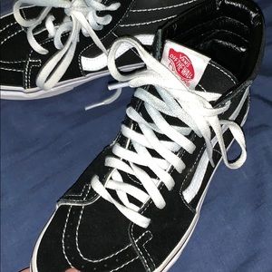 Black and white high top Vans